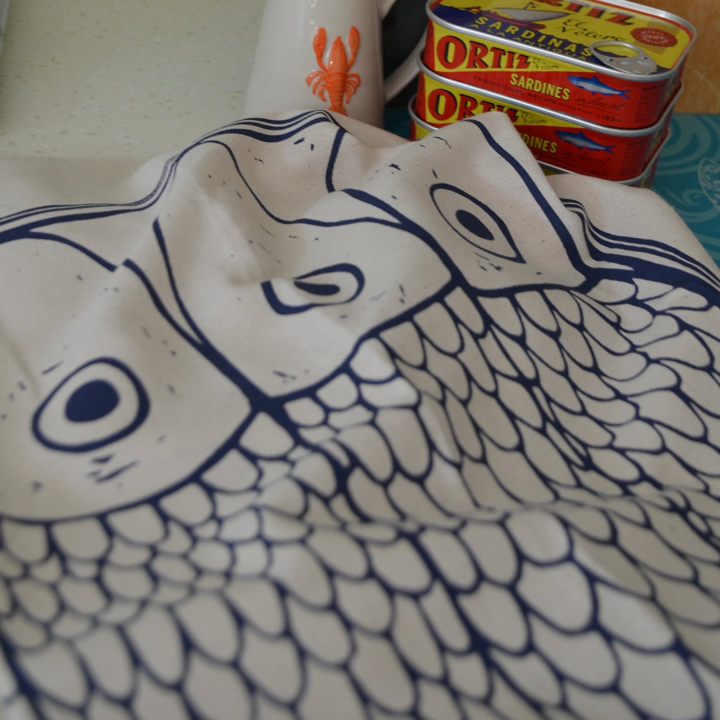 Detail of the "Sardines in a tin" tea towel designl