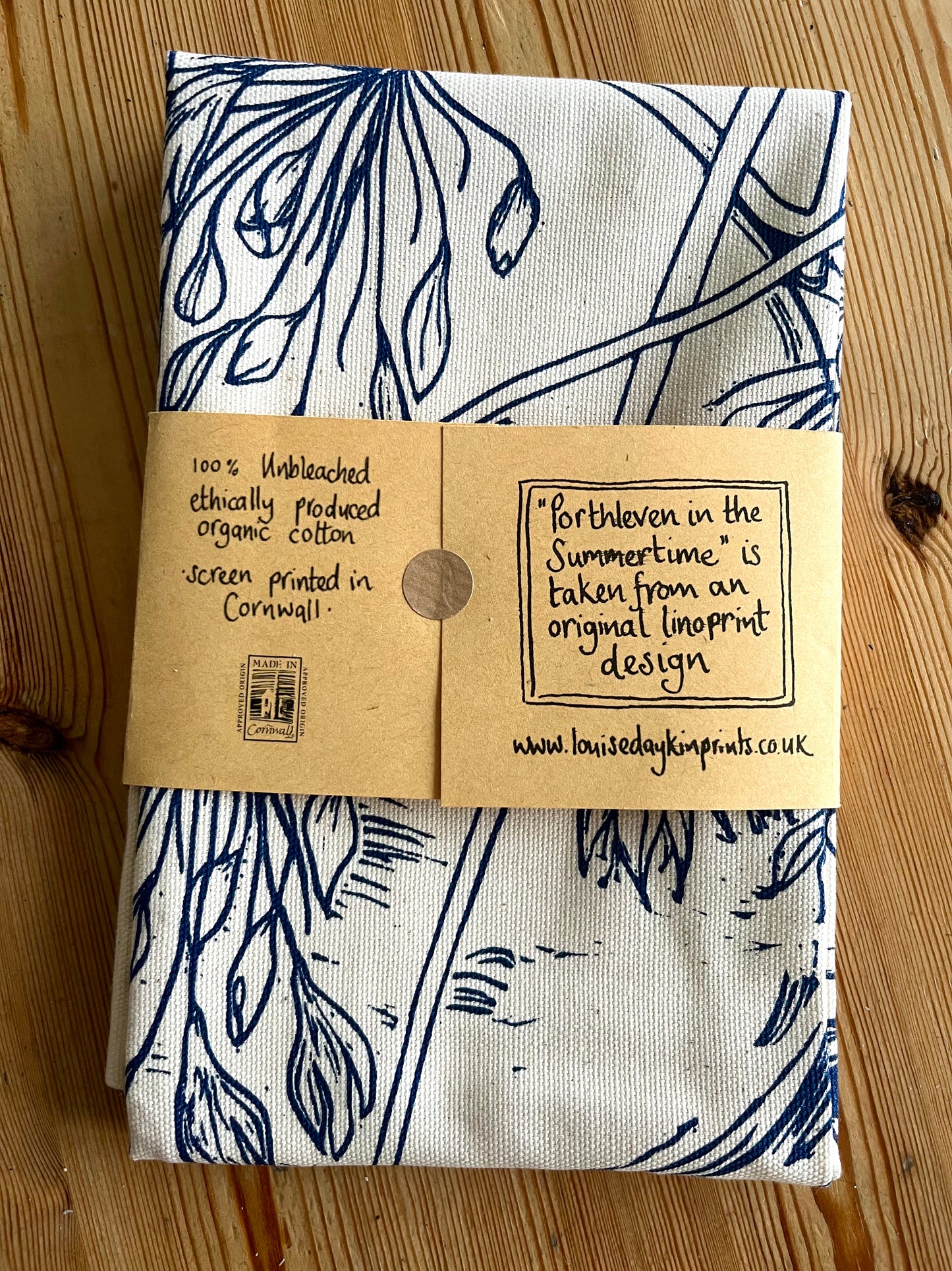 Folded back view of packaged "Porthleven in the Summertime" tea towel