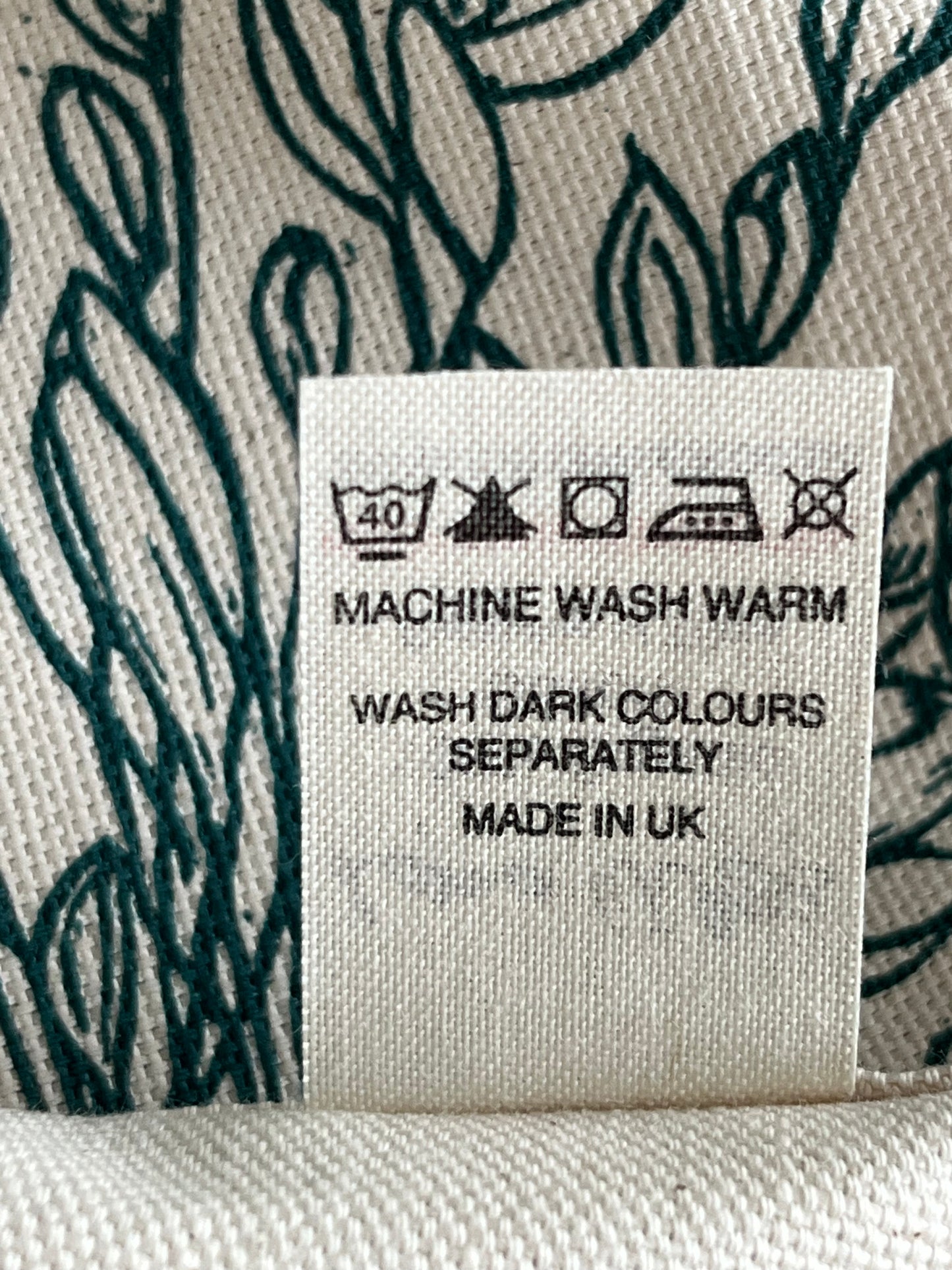 Fabric label with washing instructions on a textured fabric background