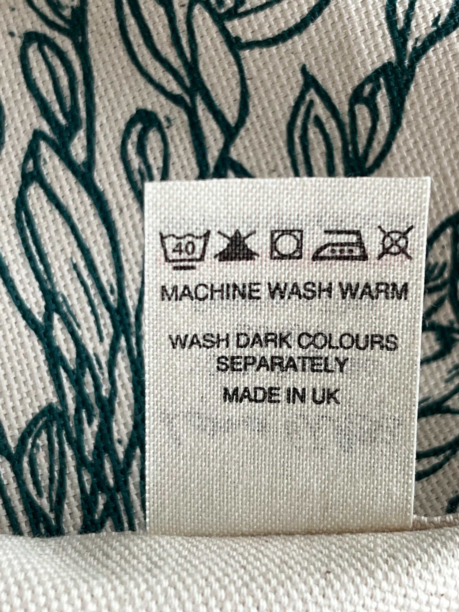 Fabric label with washing instructions on a textured fabric background
