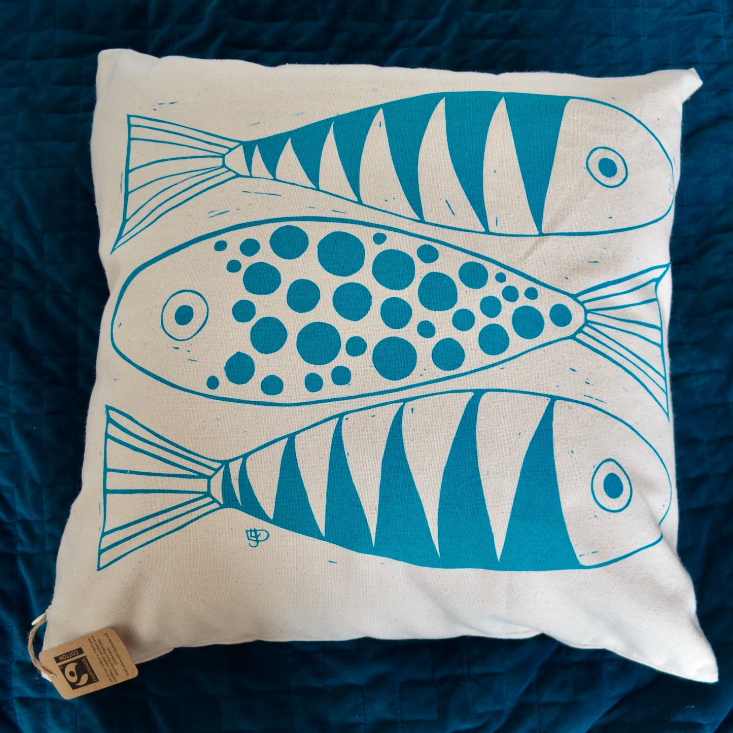Three fish cushion cover screen printed in a bright blue with a hint of turquoise. The photograph does not capture the vivid nature of the blue!
